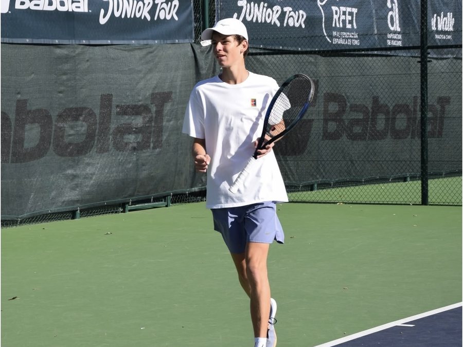 Georgiy G., an IWS student, on a tennis court at a junior tournament