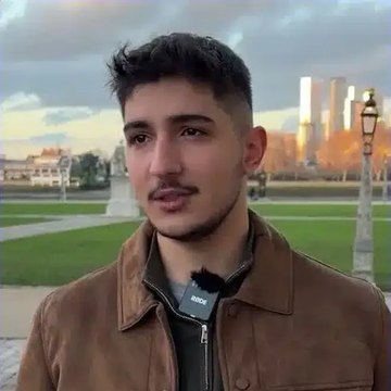 Aydın T., an IWS graduate, outdoors on a lawn