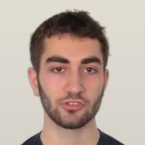 Emre K., bearded, speaking to camera against a white wall