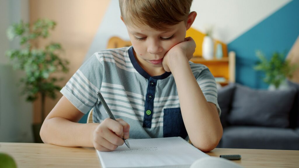 A secondary-age student studying at a desk — IWS Online School