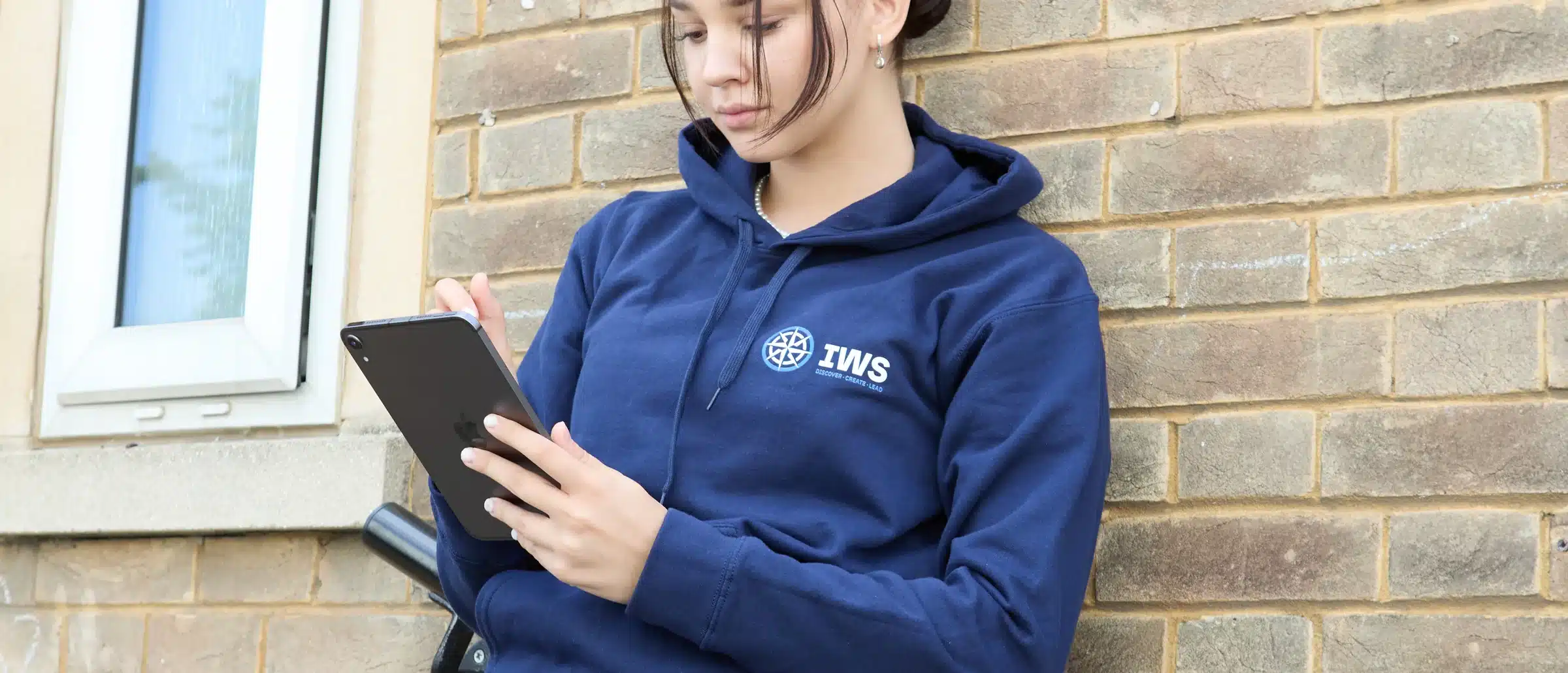 A student reading ahead on a tablet