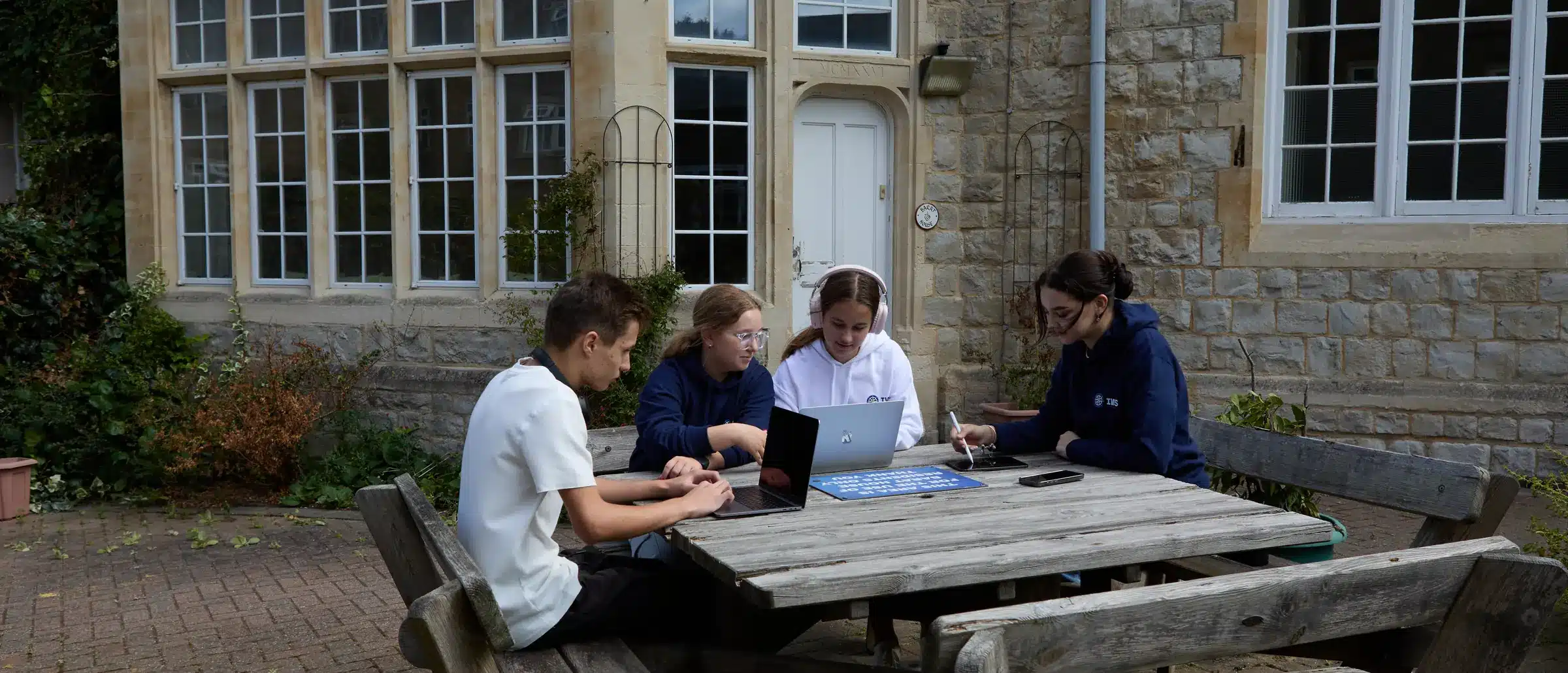 IWS students studying together at outdoor tables
